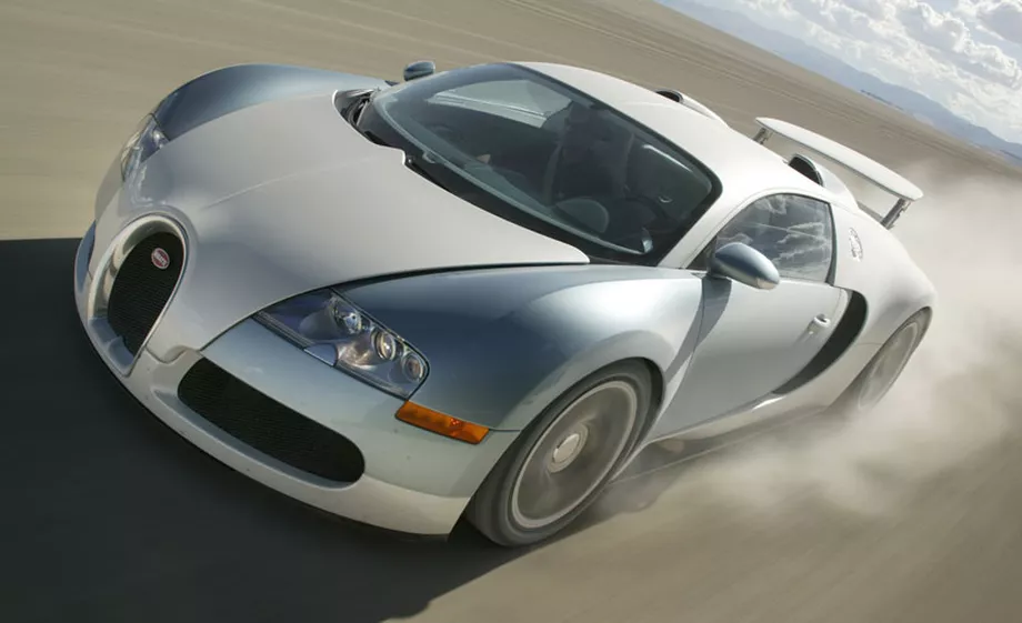 Bugatti Veyron driving on an open road, showcasing its classic design and high-performance capabilities