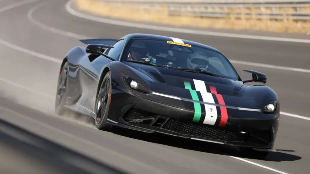 A black Pininfarina Battista with Italian flag accents racing on a track, representing electric hypercar innovation and luxury